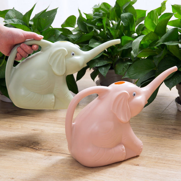 Baby elephant watering flowers
