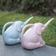 Baby elephant watering flowers